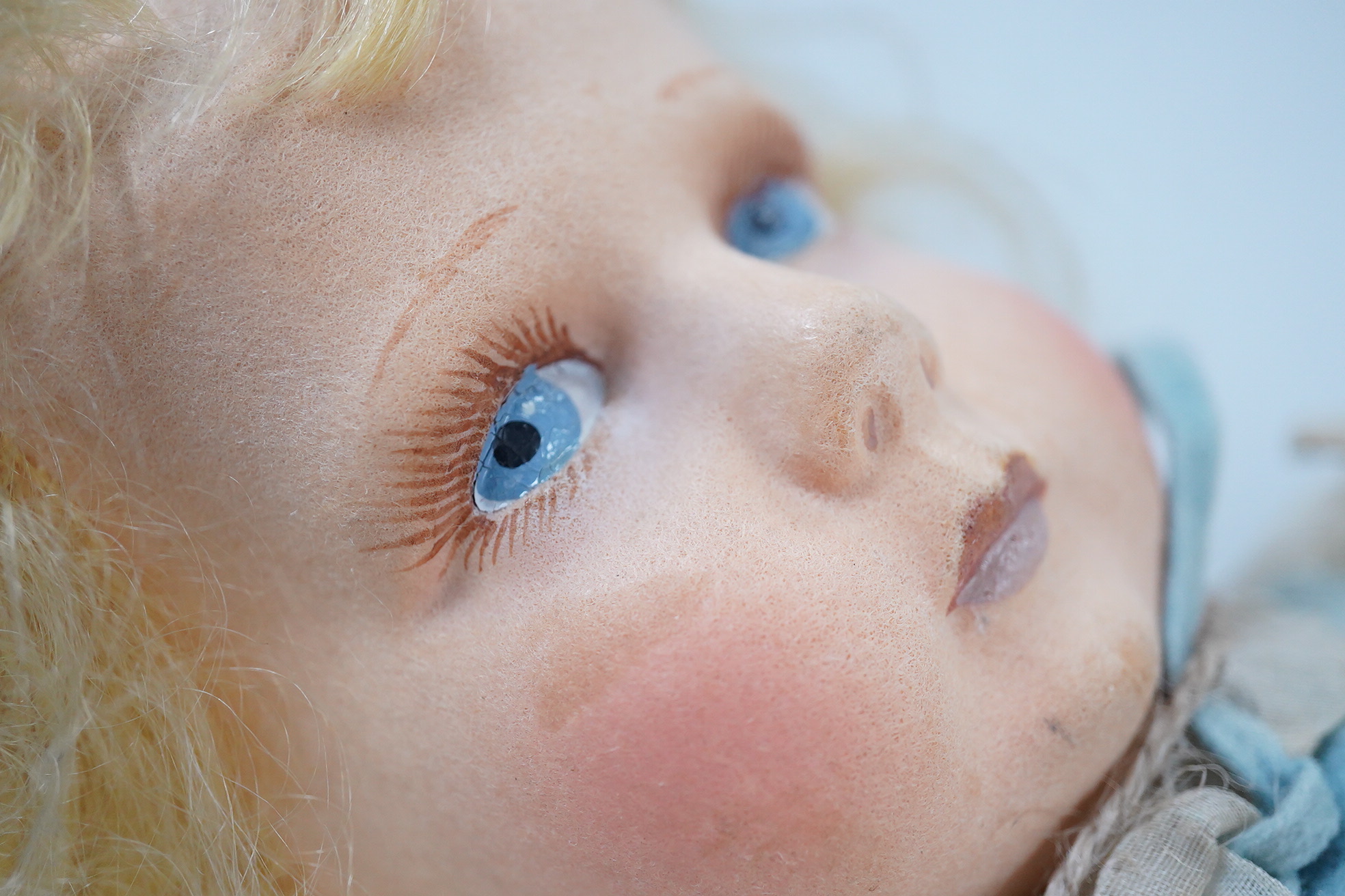 A wool felt Lenci doll with painted features to the face, 42cm long